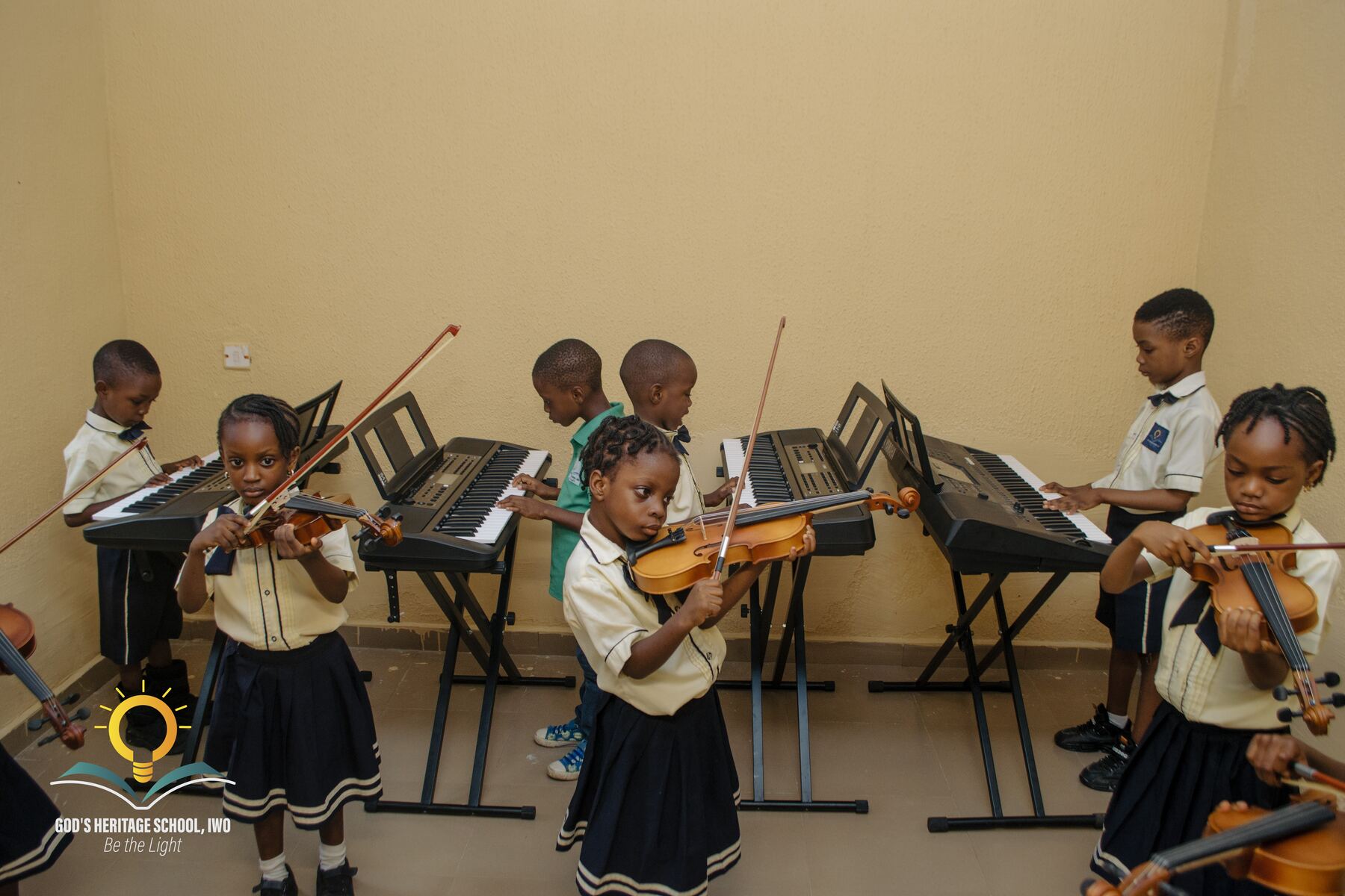 Pupils learning to play the violin at God's Heritage School